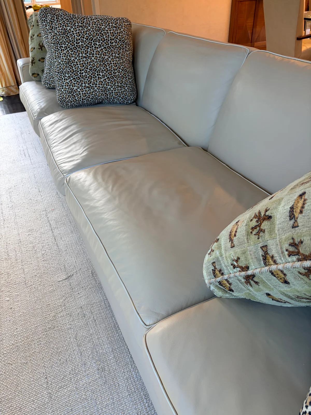 Luxury leather sofa after full color restoration — UV fading corrected and color matched across the entire piece, New York